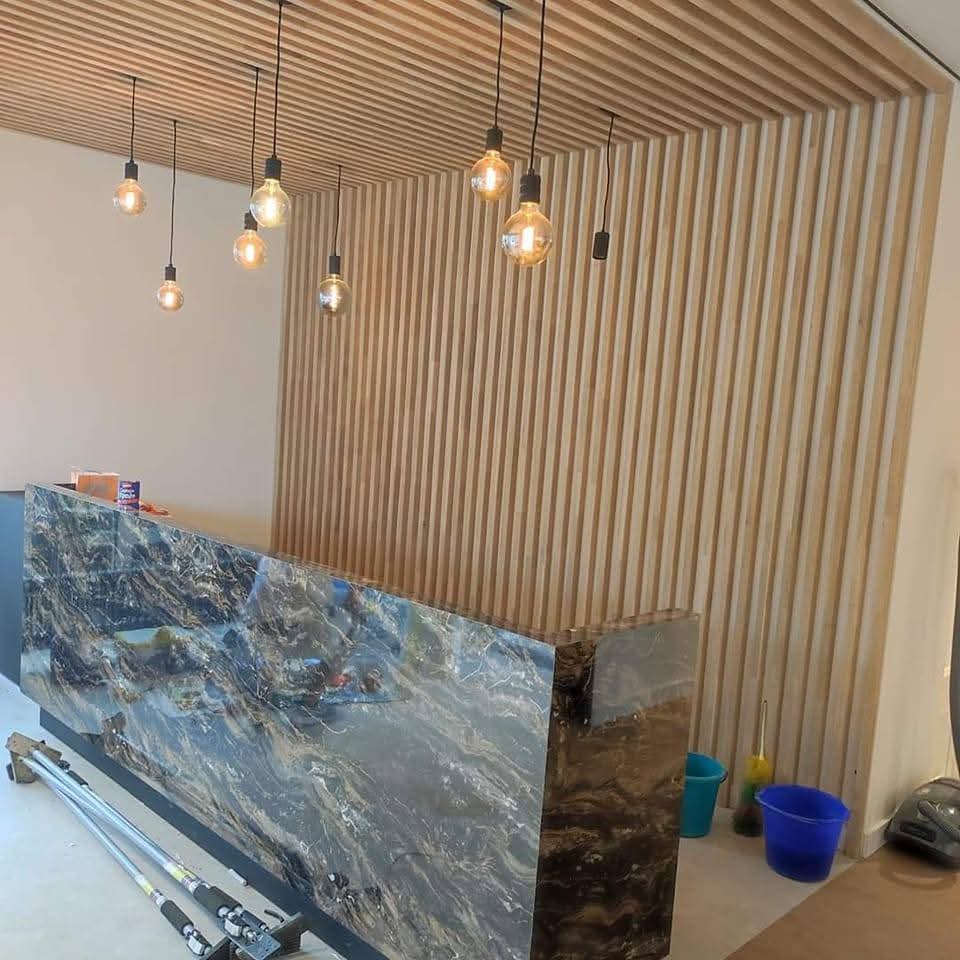 Aménagement comptoir en marbre avec tasseaux bois - Vasmat Build Bruxelles